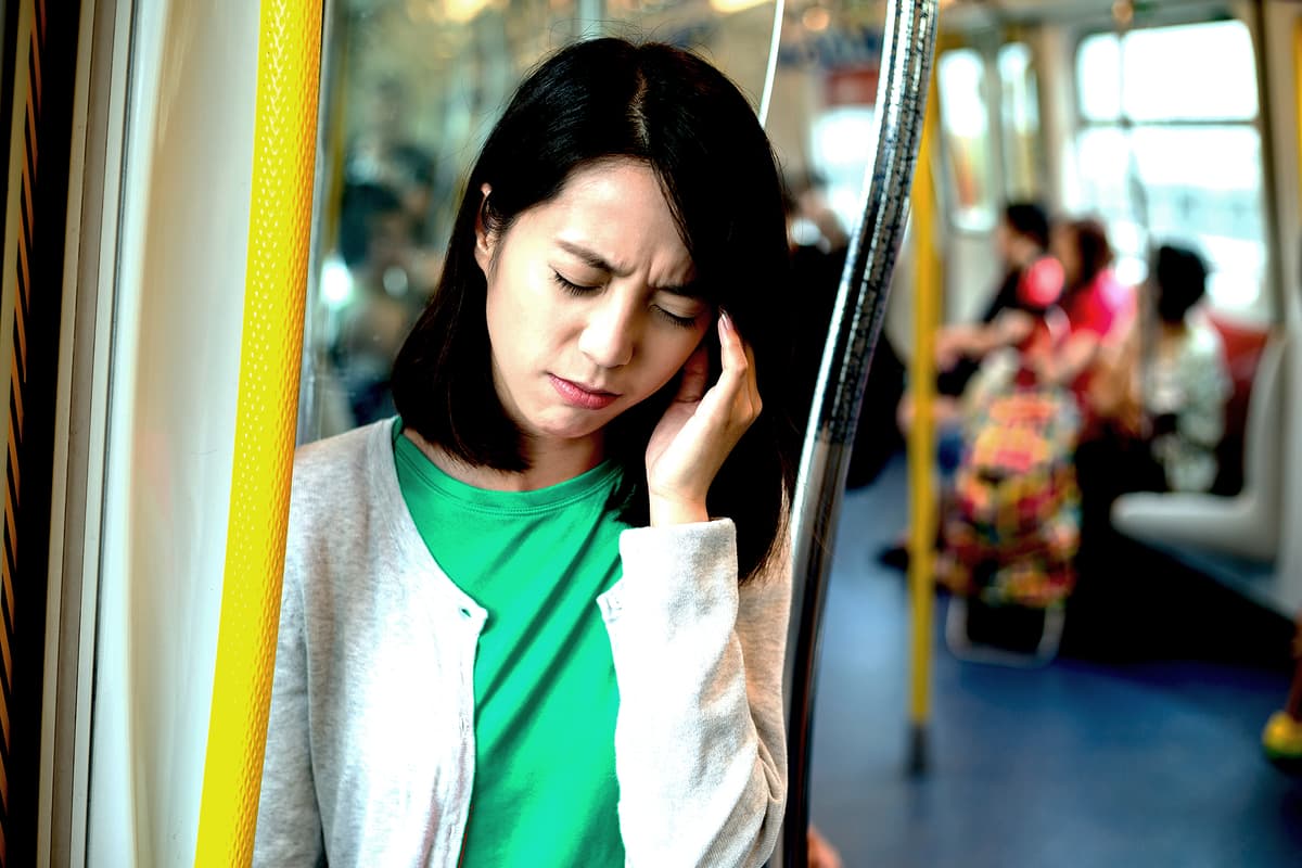 Woman experiencing tinnitus